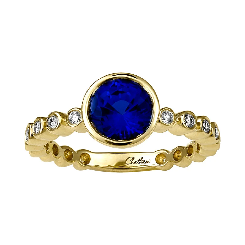 Classic Wedding Bands With Diamond Accents-14K yellow gold ring featuring a 7mm round Chatham lab grown sapphire with Chatham lab grown diamond accents, all bezel set.